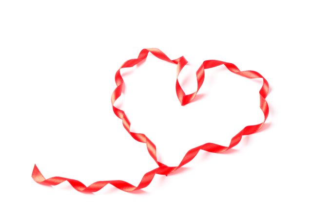 Red ribbon heart isolated on blank background