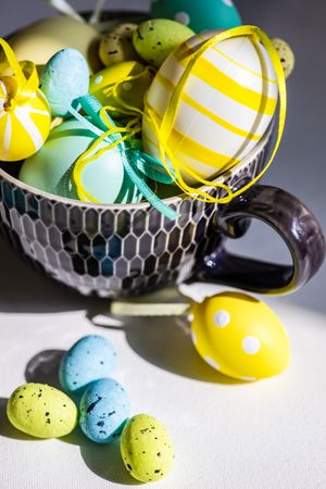 Cup of decorative pastel speckled & striped eggs