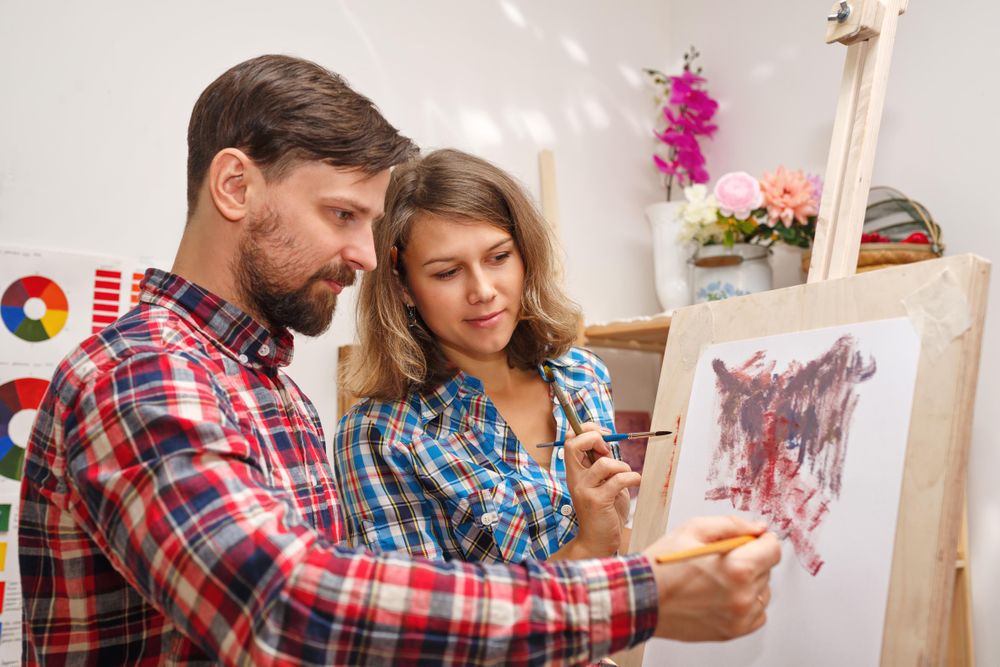 Female colleague observing painter working
