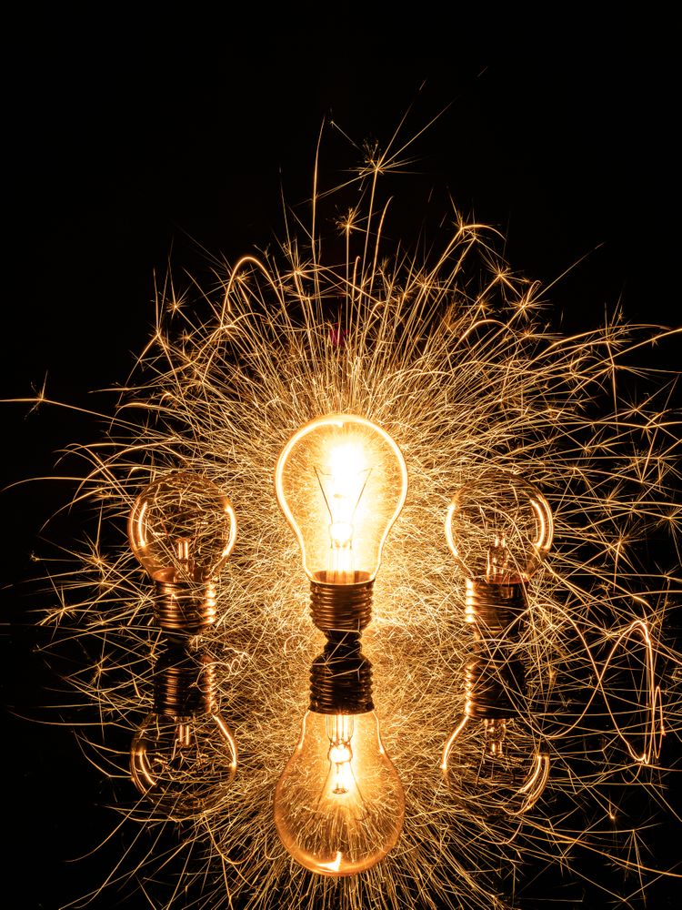 Sparkling light bulb on background