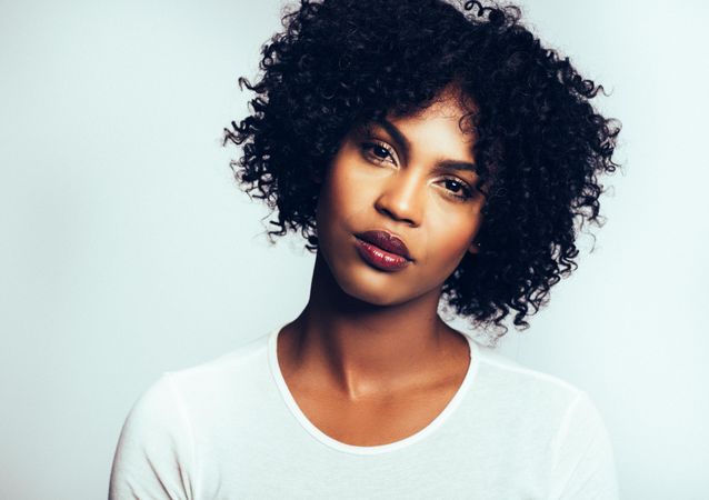 Studio portrait of serious woman with her head tilted