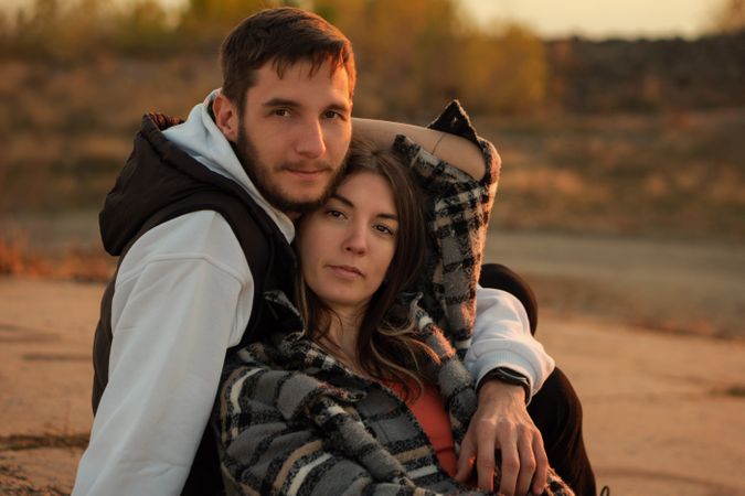 Couple sitting dusk countryside