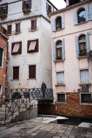 Traveler exploring city with historical buildings and waterlines