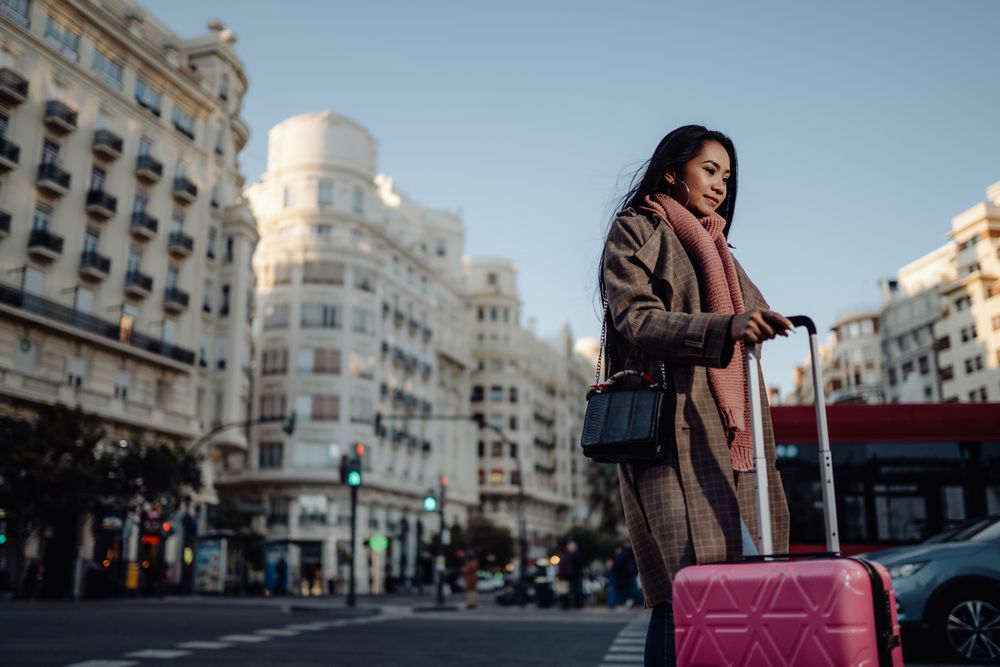 Asian tourist on sidewalk in city