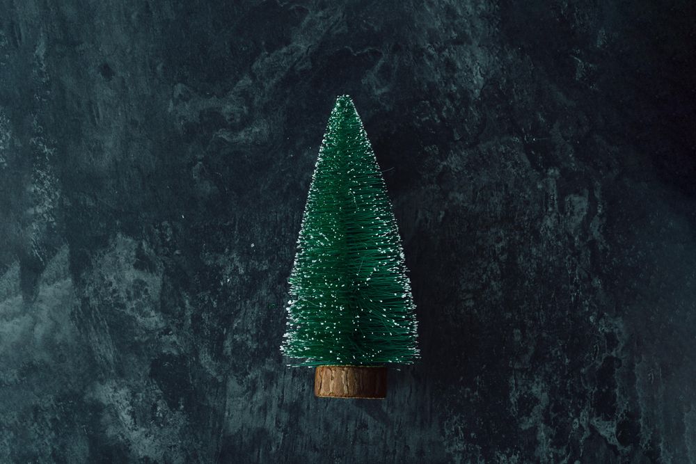 Miniature Christmas tree on dark marble table