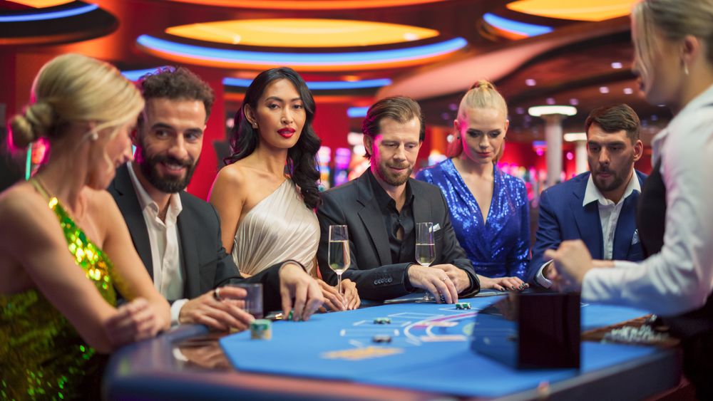 Portrait of a Glamorous Asian Woman Looks at the Camera Calls to Join her at the Table