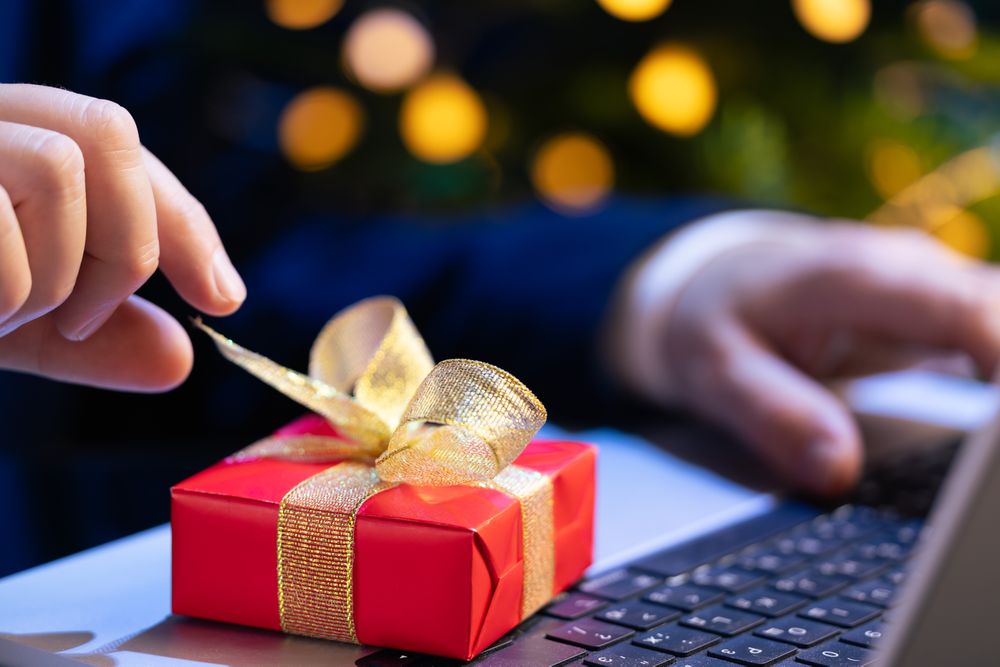 Businessman Reaching for Christmas Gift