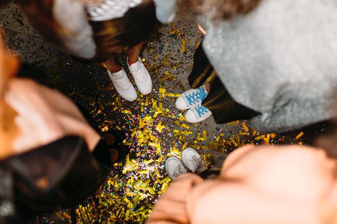 Shot of women’s feet surrounded by confetti