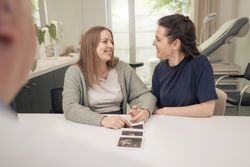 Loving lesbian couple sharing an intimate moment in a clinic.