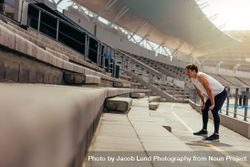Athlete working out in the stands of a stadium 4mWvgo