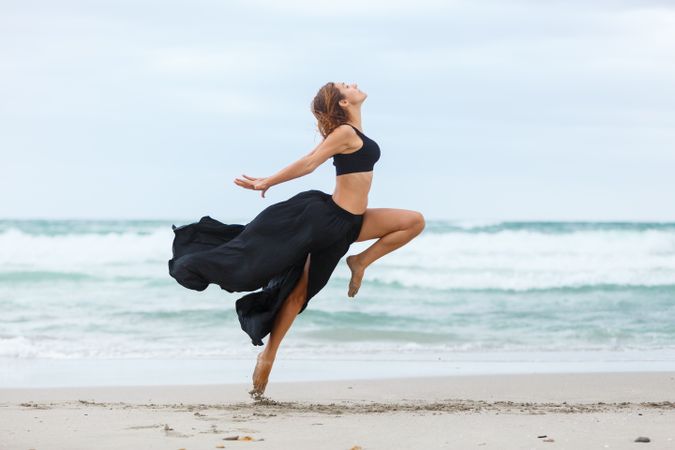 woman dancing near sea