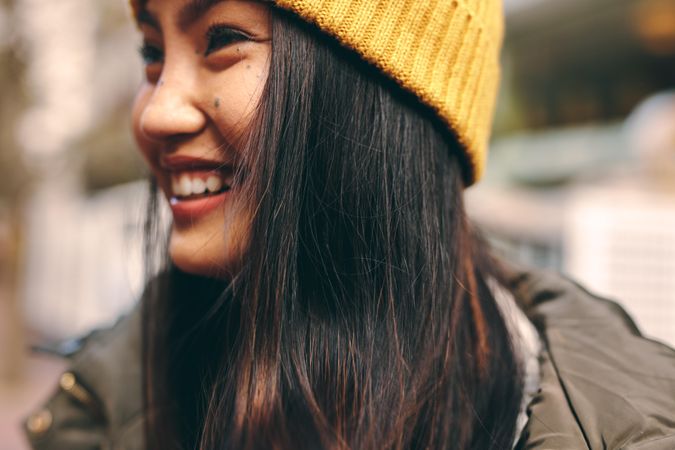 Close-up shot of young Asian woman smiling