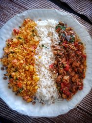 Top view bowl of rice, curry and cous cous