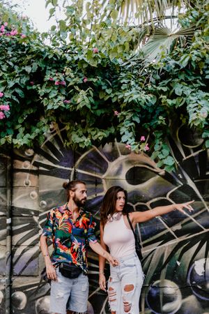 Casual friends against wall with graffiti
