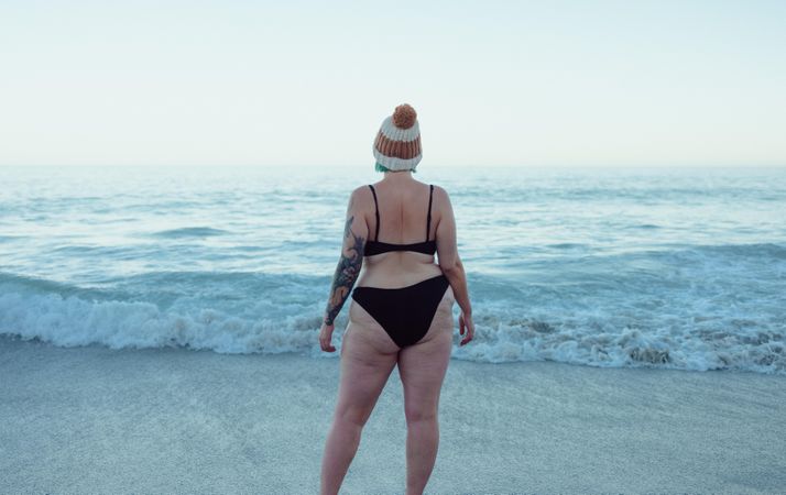 Rearview of an unrecognizable woman wearing a bikini and a wooly hat