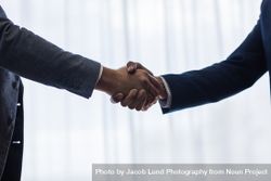 Successful business associates shaking hands 4BaPak