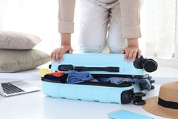 Young Woman Hand Prepare Travel Suitcase at Home,