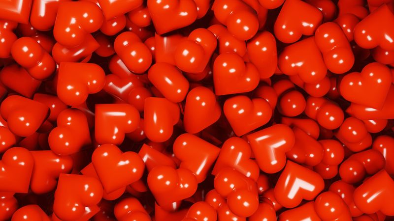 Glossy and shiny 3D red hearts background