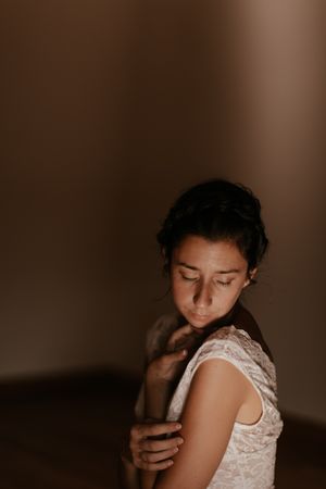 woman sitting in dark room