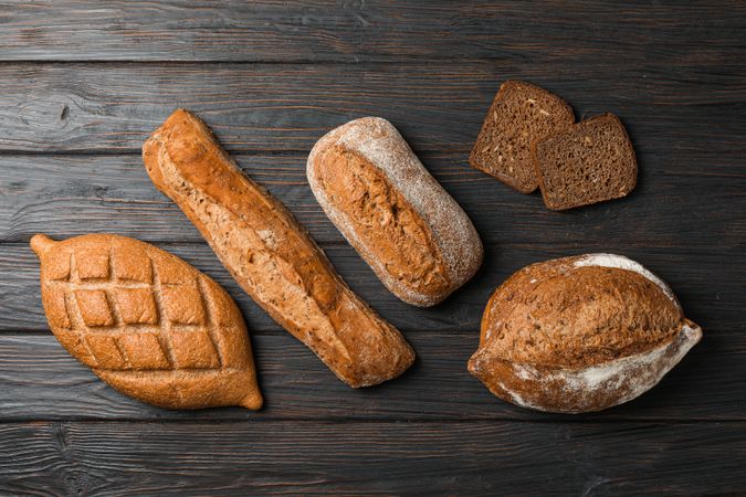 Flat lay composition with bakery products on wooden background, top view and space for text