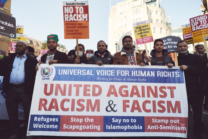 London, England, United Kingdom - March 19 2022: Men holding a banner against racism and facism