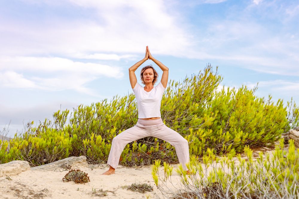 Adult lady meditating near bush