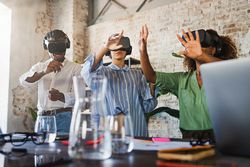 Group of multi-ethnic colleagues testing a project using virtual reality googles in the office together