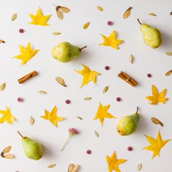 Colorful autumn pattern made of pears, leaves and flowers