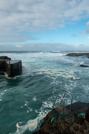 Sea waving near stone pier