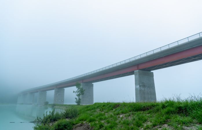 Bridge over Sylvenstein lake on a foggy morning, side view from under the bridge