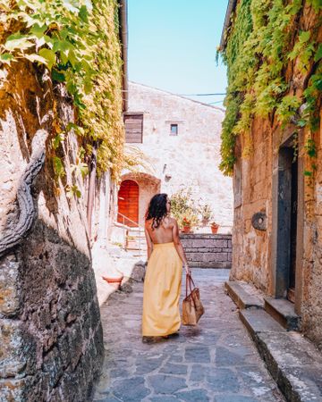Woman walking in alley in Italy