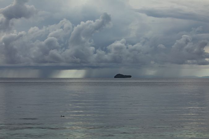 Storm clouds on a rainy day, over the ocean, small island of Friwin, West Papua, Indonesia