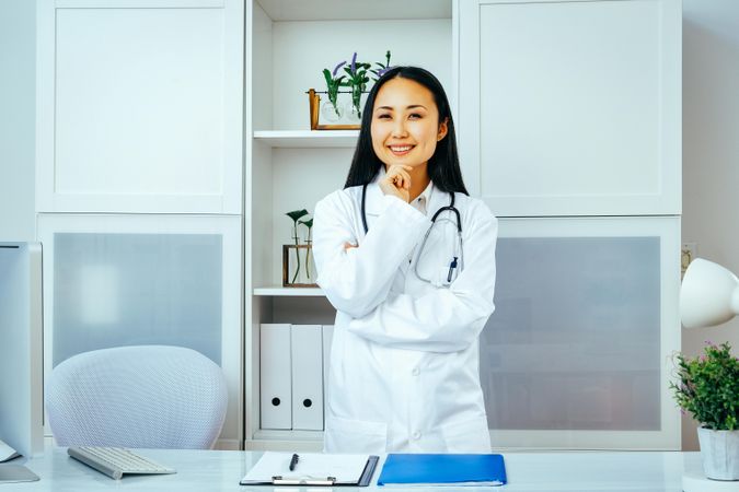 Asian doctor thinking about something in her office