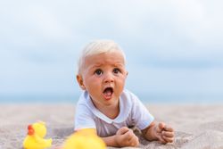 Baby boy playing with rubber ducks