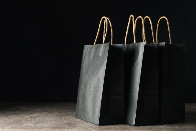 Paper bags against dark background, space for text
