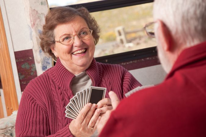 Happy Older Adult Couple Playing Cards