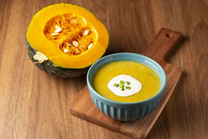 Bowl with pumpkin soup on the table.