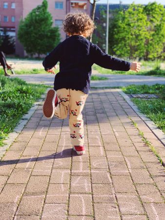 Boy playing hopscotch