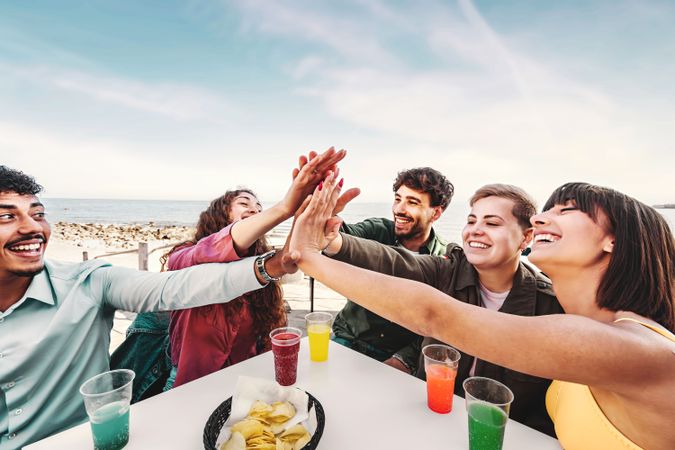 Diverse Friends Celebrating with High-Five Outdoors