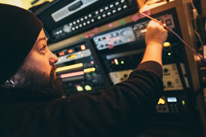 Man adjusting sound control in a studio