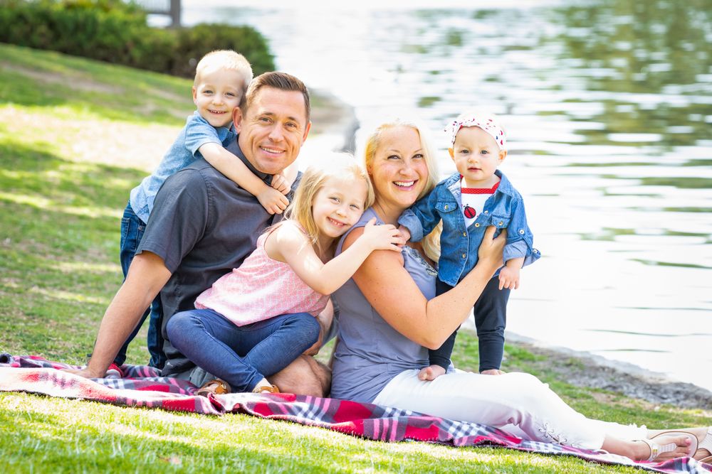 Happy Young Family Portrait In The Park
