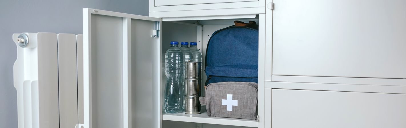 Emergency backpack and first aid kit kept in a closet