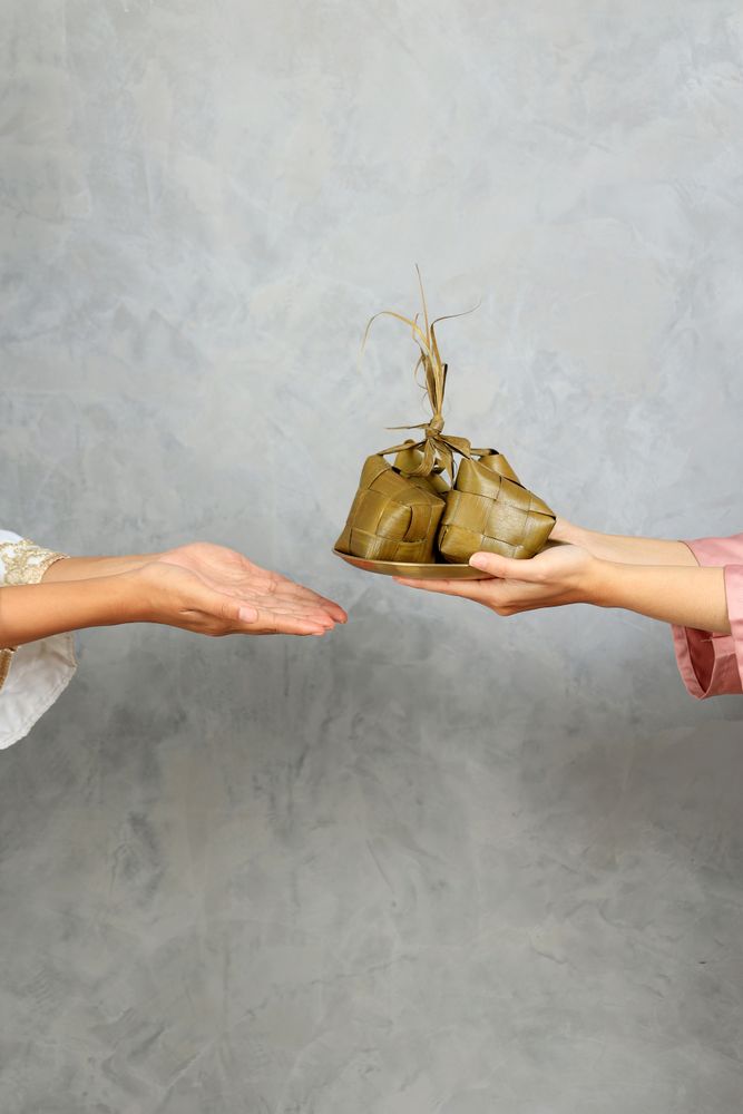 Sharing Ketupat, Two Female Sharing Diamond Shape Rice Cake