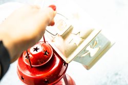 Person holding decorative Christmas lanterns