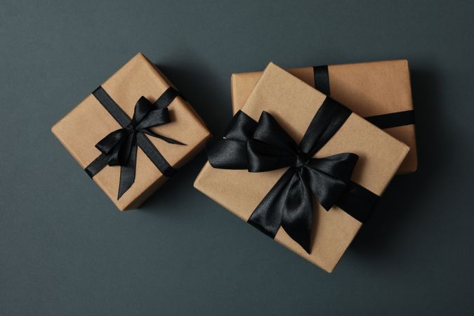 Craft gift boxes with bow on gray background