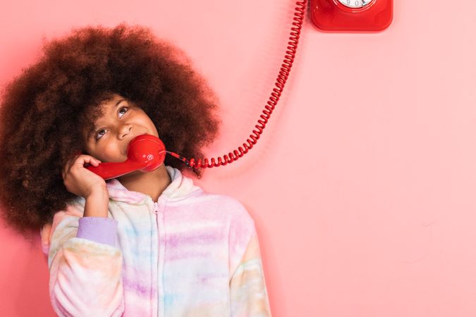 Black girl speaking on telephone in studio