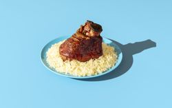 Roasted pork knuckle with sauerkraut minimalist on a blue table