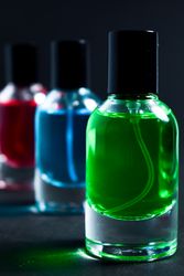 Different colored glass bottles in grey studio
