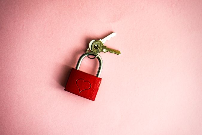 Valentine's concept with locked red padlock in pink background