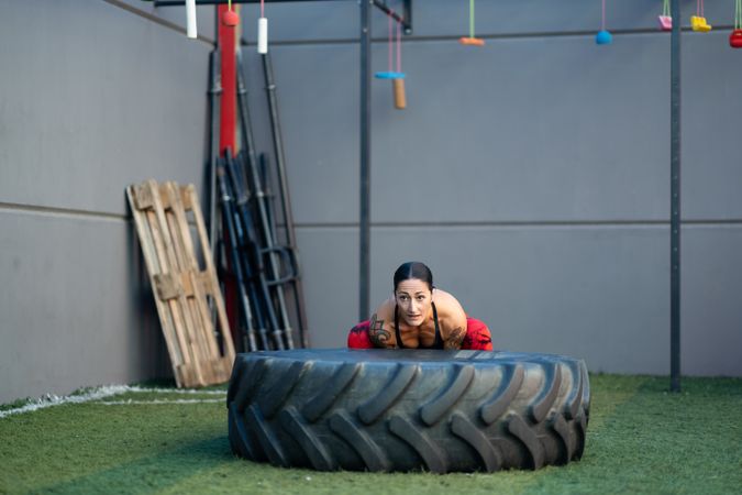 Fit woman working out with tire